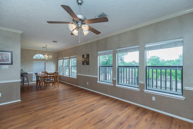 2601 Sailboat Dr, Houston, TX 77058 - empty room with wood finished floors, a chandelier, a textured ceiling, and a ceiling fan