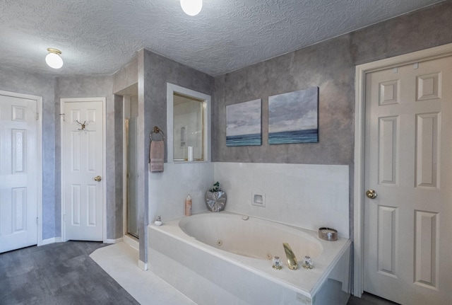 2601 Sailboat Dr, Houston, TX 77058 - bathroom with a jetted tub, a shower stall, wood finished floors, and a textured ceiling