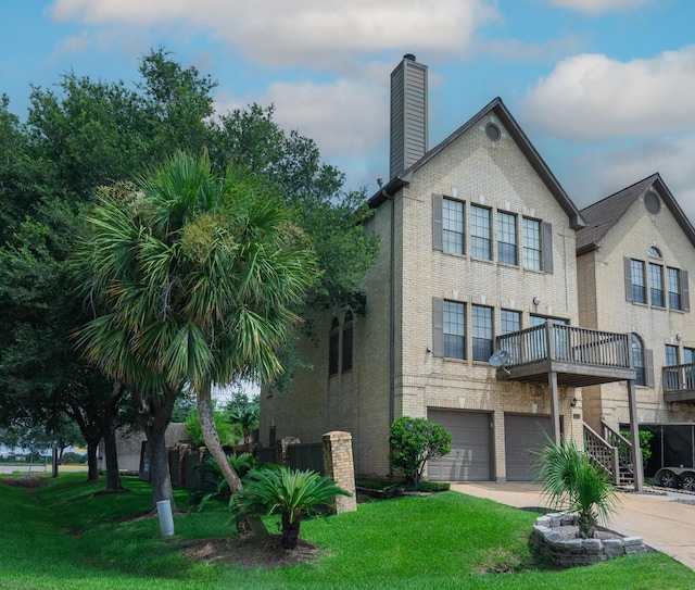 2601 Sailboat Dr, Houston, TX 77058 - back of house with brick siding, driveway, an attached garage, and a chimney