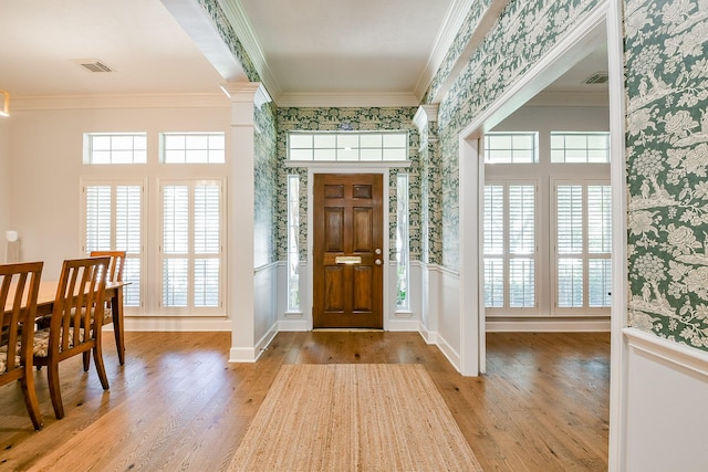 2442 Chimney Rock Rd, Houston, TX 77056 - foyer entrance with wallpapered walls, wood finished floors, crown molding, and wainscoting