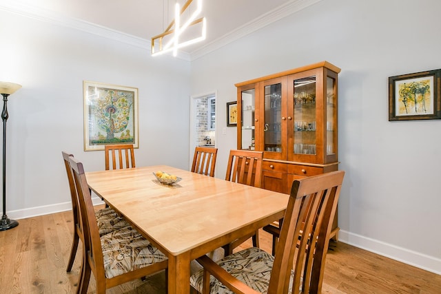 2442 Chimney Rock Rd, Houston, TX 77056 - dining area with crown molding and light wood-style flooring