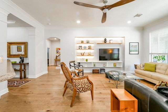 2442 Chimney Rock Rd, Houston, TX 77056 - living area with arched walkways, ornamental molding, a ceiling fan, light wood finished floors, and recessed lighting