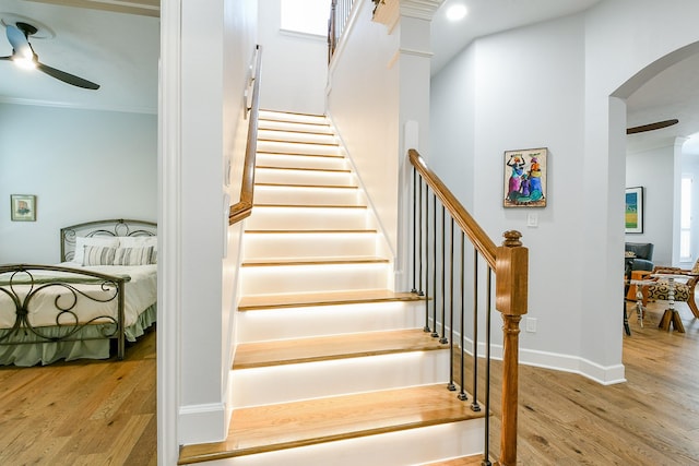 2442 Chimney Rock Rd, Houston, TX 77056 - stairway with arched walkways, ceiling fan, wood finished floors, and ornamental molding