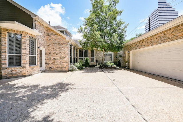 2442 Chimney Rock Rd, Houston, TX 77056 - view of patio featuring driveway and a garage