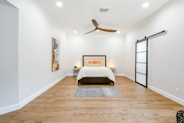 2442 Chimney Rock Rd, Houston, TX 77056 - bedroom with a barn door, ornamental molding, recessed lighting, light wood-type flooring, and a ceiling fan