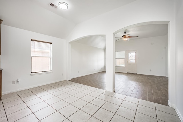 5919 Glenneyre Ln, Houston, TX 77084 - empty room featuring a ceiling fan, arched walkways, vaulted ceiling, and wood finished floors