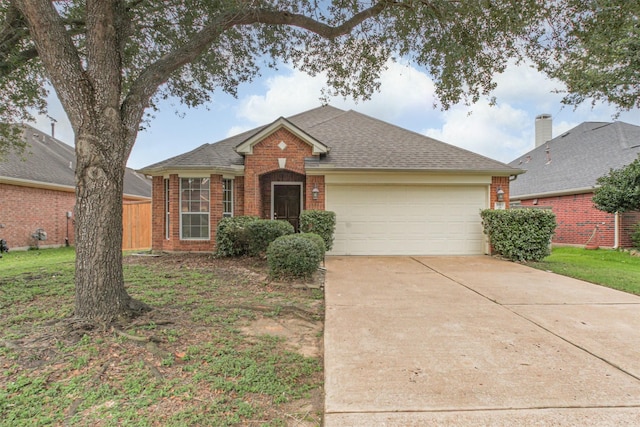 5919 Glenneyre Ln, Houston, TX 77084 - view of front facade featuring brick siding, a garage, concrete driveway, and a shingled roof