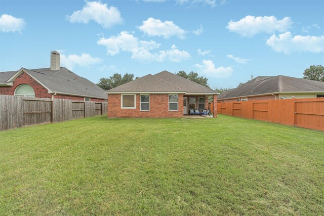 5919 Glenneyre Ln, Houston, TX 77084 - rear view of property with a fenced backyard and brick siding