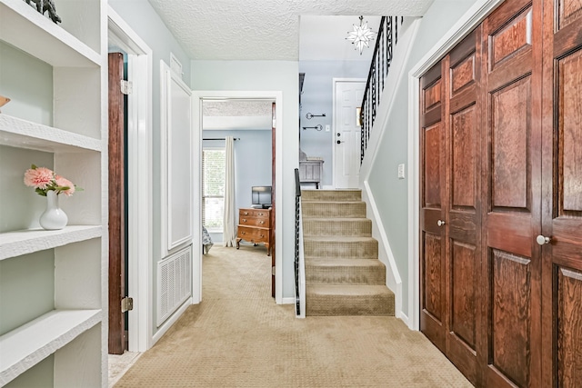 2114 Crows Nest Dr, League City, TX 77573 - hall featuring light colored carpet, stairway, and a textured ceiling