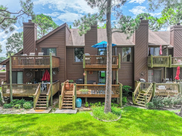 2114 Crows Nest Dr, League City, TX 77573 - rear view of house featuring a balcony, a chimney, a lawn, and a wooden deck