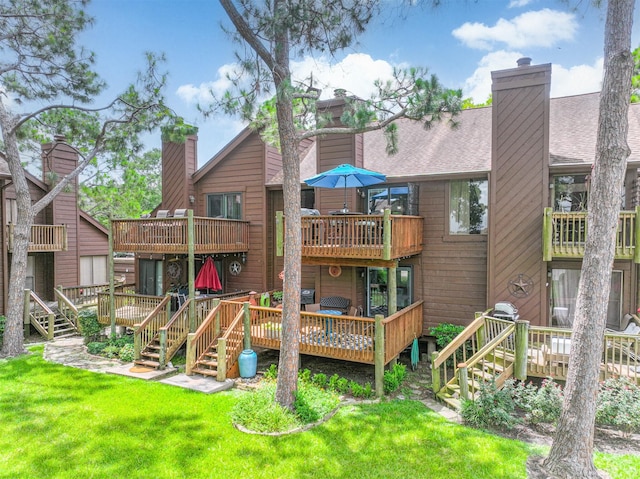 2114 Crows Nest Dr, League City, TX 77573 - back of house with a chimney, a deck, and a yard