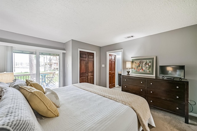 2114 Crows Nest Dr, League City, TX 77573 - carpeted bedroom featuring access to outside, a textured ceiling, and ensuite bathroom