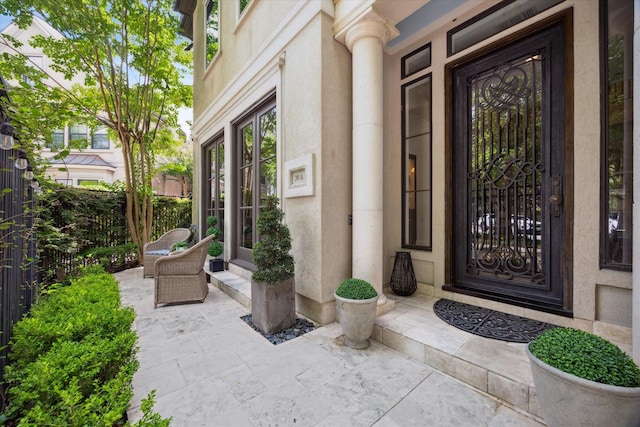 30 Hackberry Ln Unit A, Houston, TX 77027 - doorway to property with stucco siding and a patio area