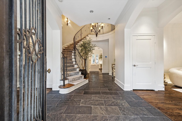 30 Hackberry Ln Unit A, Houston, TX 77027 - foyer featuring stairs, stone tile floors, arched walkways, a chandelier, and crown molding