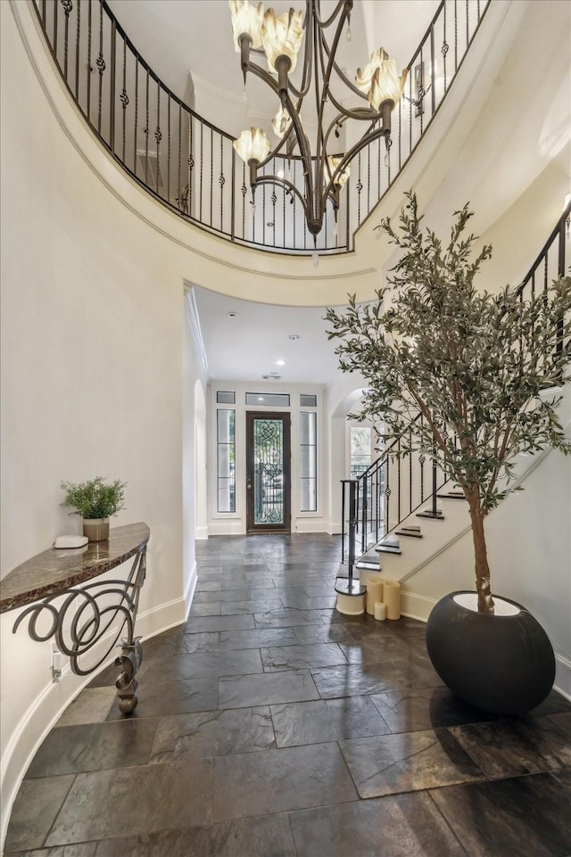 30 Hackberry Ln Unit A, Houston, TX 77027 - foyer entrance featuring stairs, stone tile floors, a high ceiling, and a chandelier
