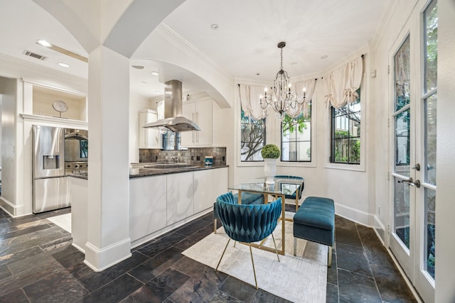 30 Hackberry Ln Unit A, Houston, TX 77027 - kitchen featuring island range hood, stainless steel fridge with ice dispenser, dark countertops, stone tile flooring, and crown molding