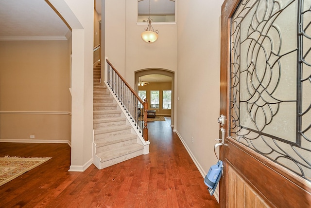 21211 Dover Park Ln, Katy, TX 77450 - foyer with arched walkways, stairway, ornamental molding, and wood finished floors