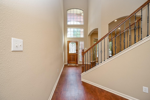 21211 Dover Park Ln, Katy, TX 77450 - entryway with arched walkways, dark wood-style flooring, a towering ceiling, and stairway