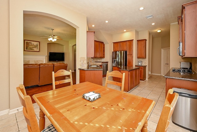 21211 Dover Park Ln, Katy, TX 77450 - dining room with light tile patterned flooring, arched walkways, ceiling fan, and recessed lighting