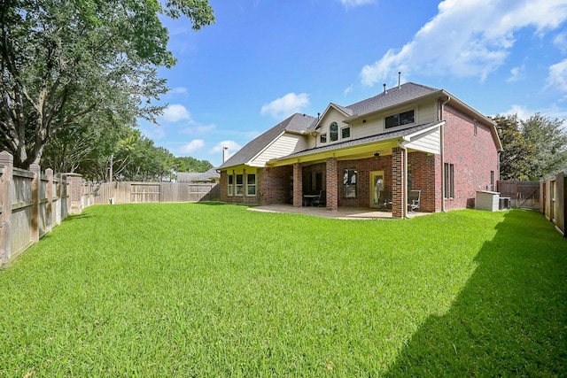 21211 Dover Park Ln, Katy, TX 77450 - back of house featuring brick siding, a patio area, a fenced backyard, and roof with shingles