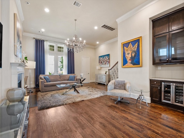 249 E 27th St, Houston, TX 77008 - living room with wine cooler, ornamental molding, a chandelier, dark wood-type flooring, and recessed lighting