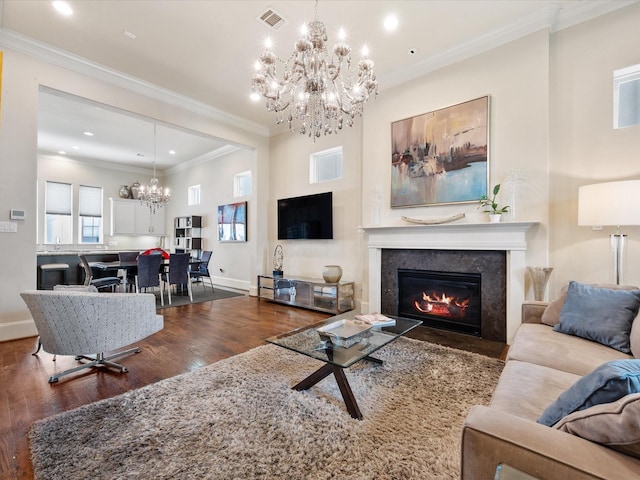 249 E 27th St, Houston, TX 77008 - living area featuring a chandelier, dark wood finished floors, a glass covered fireplace, recessed lighting, and ornamental molding