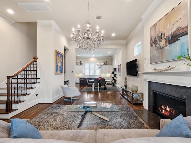 249 E 27th St, Houston, TX 77008 - living room with a chandelier, wood finished floors, stairway, ornamental molding, and a high end fireplace
