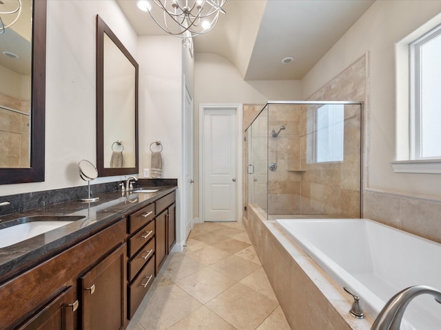 249 E 27th St, Houston, TX 77008 - full bath with tiled tub, a tile shower, double vanity, tile patterned floors, and a chandelier