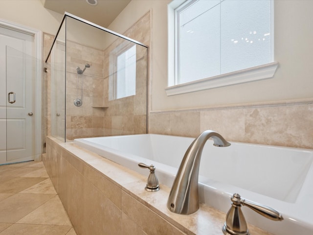 249 E 27th St, Houston, TX 77008 - full bathroom featuring tiled bath, tiled shower, and tile patterned floors