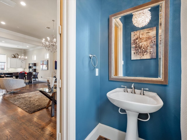 249 E 27th St, Houston, TX 77008 - bathroom with a chandelier, crown molding, and wood finished floors