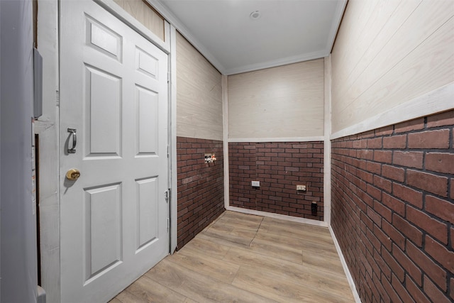 4505 Memorial Dr, Waco, TX 76711 - laundry area with brick wall, light wood-style floors, and ornamental molding