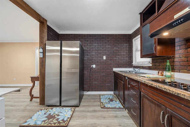 4505 Memorial Dr, Waco, TX 76711 - kitchen with freestanding refrigerator, brick wall, exhaust hood, light wood-style floors, and ornamental molding