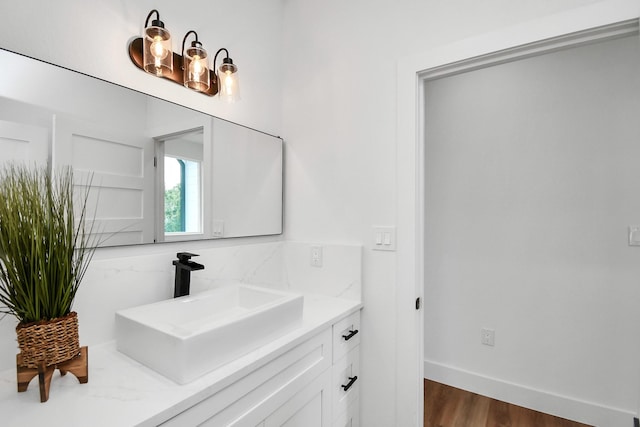 235 Julia St Unit B, Houston, TX 77022 - bathroom with vanity, wood finished floors, backsplash, and a chandelier