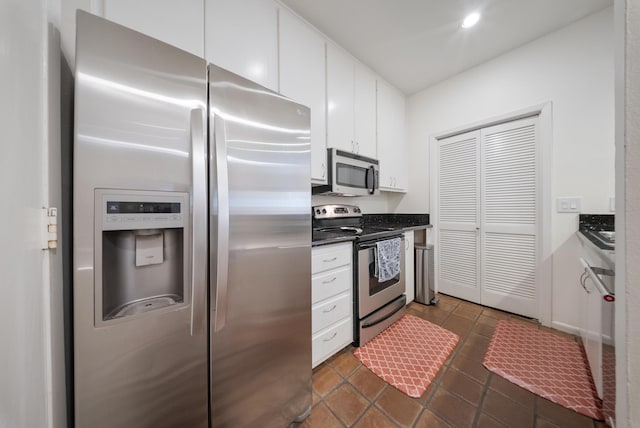 4904 Feagan St Unit 1, Houston, TX 77007 - kitchen with appliances with stainless steel finishes, white cabinets, dark countertops, dark tile patterned floors, and recessed lighting
