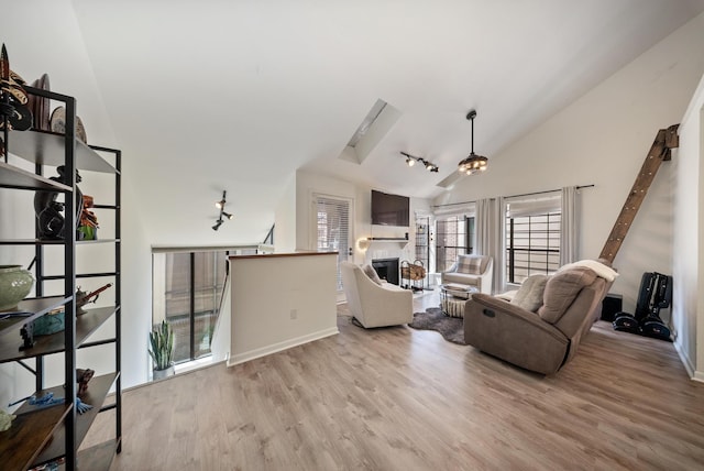 4904 Feagan St Unit 1, Houston, TX 77007 - living area featuring vaulted ceiling, wood finished floors, and a glass covered fireplace