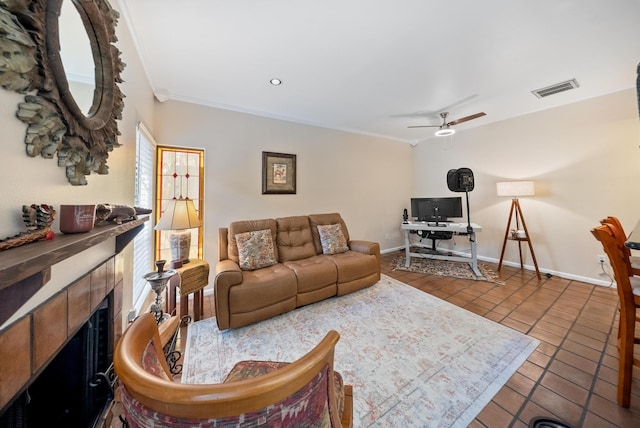 4904 Feagan St Unit 1, Houston, TX 77007 - living area with ceiling fan, tile patterned flooring, a tiled fireplace, ornamental molding, and an office area