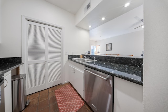 4904 Feagan St Unit 1, Houston, TX 77007 - kitchen with stainless steel dishwasher, white cabinets, recessed lighting, dark tile patterned floors, and dark stone counters