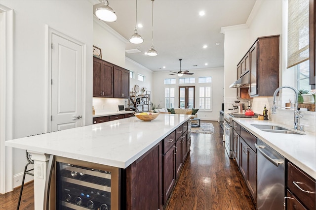 1035 Waverly St Unit B, Houston, TX 77008 - kitchen with stainless steel appliances, crown molding, beverage cooler, a center island, and dark wood-style flooring