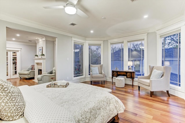 2317 Ashland St, Houston, TX 77008 - bedroom with wood finished floors, a fireplace, ornamental molding, and recessed lighting