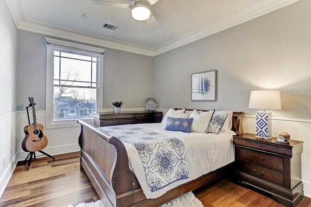 2317 Ashland St, Houston, TX 77008 - bedroom with wood finished floors, wainscoting, crown molding, and a ceiling fan