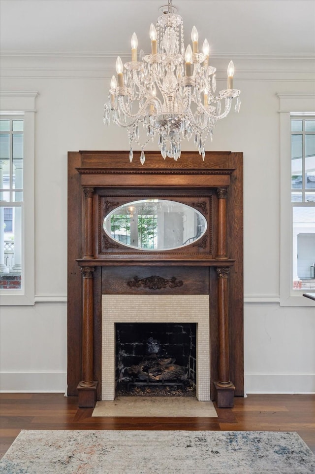 2317 Ashland St, Houston, TX 77008 - detailed view of wood finished floors, ornamental molding, a fireplace with flush hearth, and a chandelier
