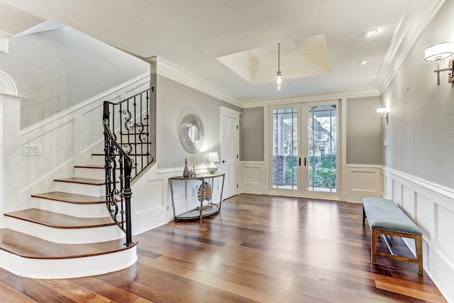 2317 Ashland St, Houston, TX 77008 - entrance foyer featuring a decorative wall, a tray ceiling, wood finished floors, stairs, and french doors