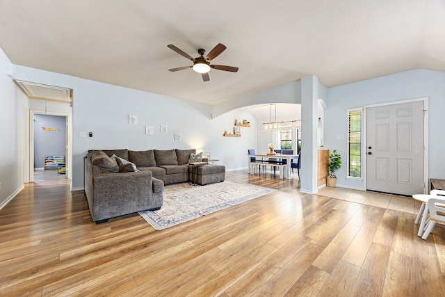 2715 Lexington Park Dr, Spring, TX 77373 - living area with attic access, arched walkways, a ceiling fan, light wood-type flooring, and lofted ceiling