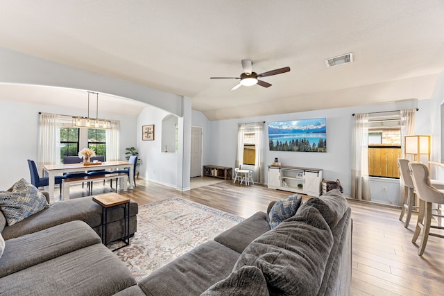 2715 Lexington Park Dr, Spring, TX 77373 - living room featuring ceiling fan, wood finished floors, arched walkways, and vaulted ceiling