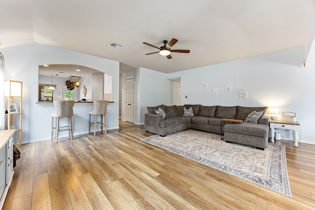 2715 Lexington Park Dr, Spring, TX 77373 - living area featuring a ceiling fan, arched walkways, wood finished floors, and lofted ceiling