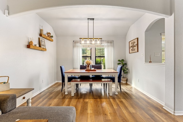 2715 Lexington Park Dr, Spring, TX 77373 - dining area with arched walkways, vaulted ceiling, and wood finished floors