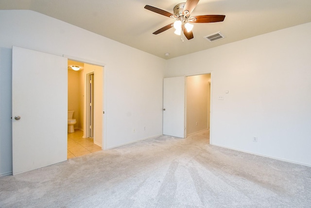 2715 Trinity Glen Ln, Houston, TX 77047 - unfurnished bedroom with light colored carpet, connected bathroom, and a ceiling fan
