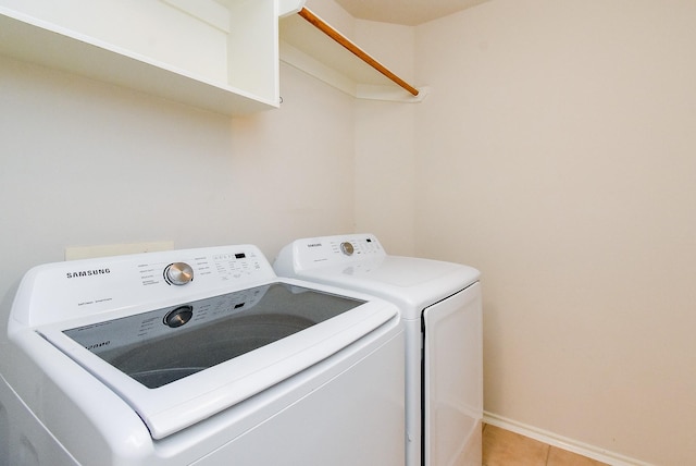 2715 Trinity Glen Ln, Houston, TX 77047 - laundry room with washer and dryer and light tile patterned flooring