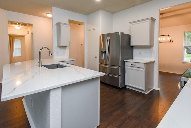2715 Trinity Glen Ln, Houston, TX 77047 - kitchen featuring stainless steel fridge, dark wood-type flooring, light stone counters, a peninsula, and decorative backsplash