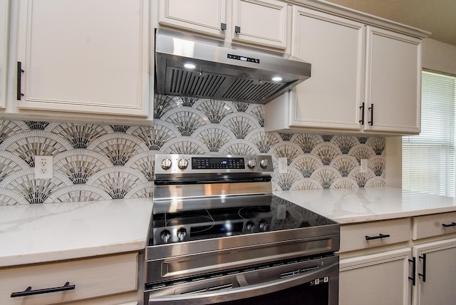 2715 Trinity Glen Ln, Houston, TX 77047 - kitchen featuring under cabinet range hood, stainless steel range with electric stovetop, decorative backsplash, and light stone countertops